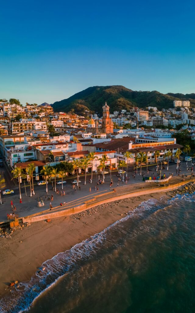 an aerial view of a beach with a city in the background